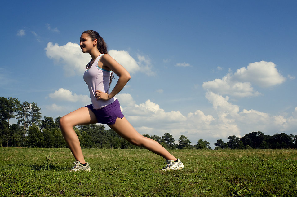 15250 a young woman stretching outdoors before exercising pv